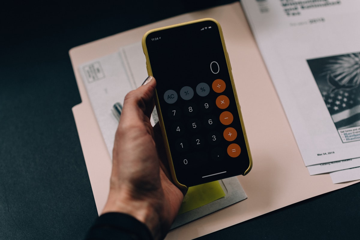 Accountant reviewing financial spreadsheets and tax documents at desk - accountant resume that gets hired
