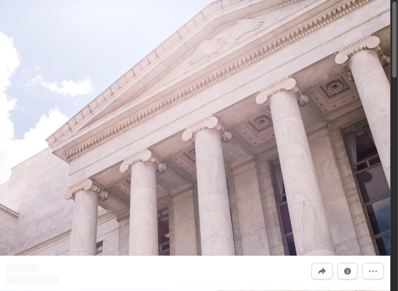 A classical government building facade with tall columns, representing writing a resume for a government job