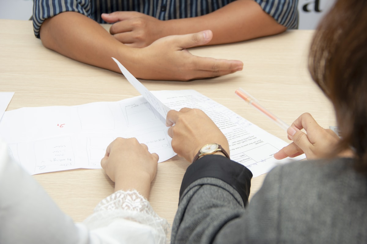 Two people in a focused job interview conversation - answer what is your greatest weakness
