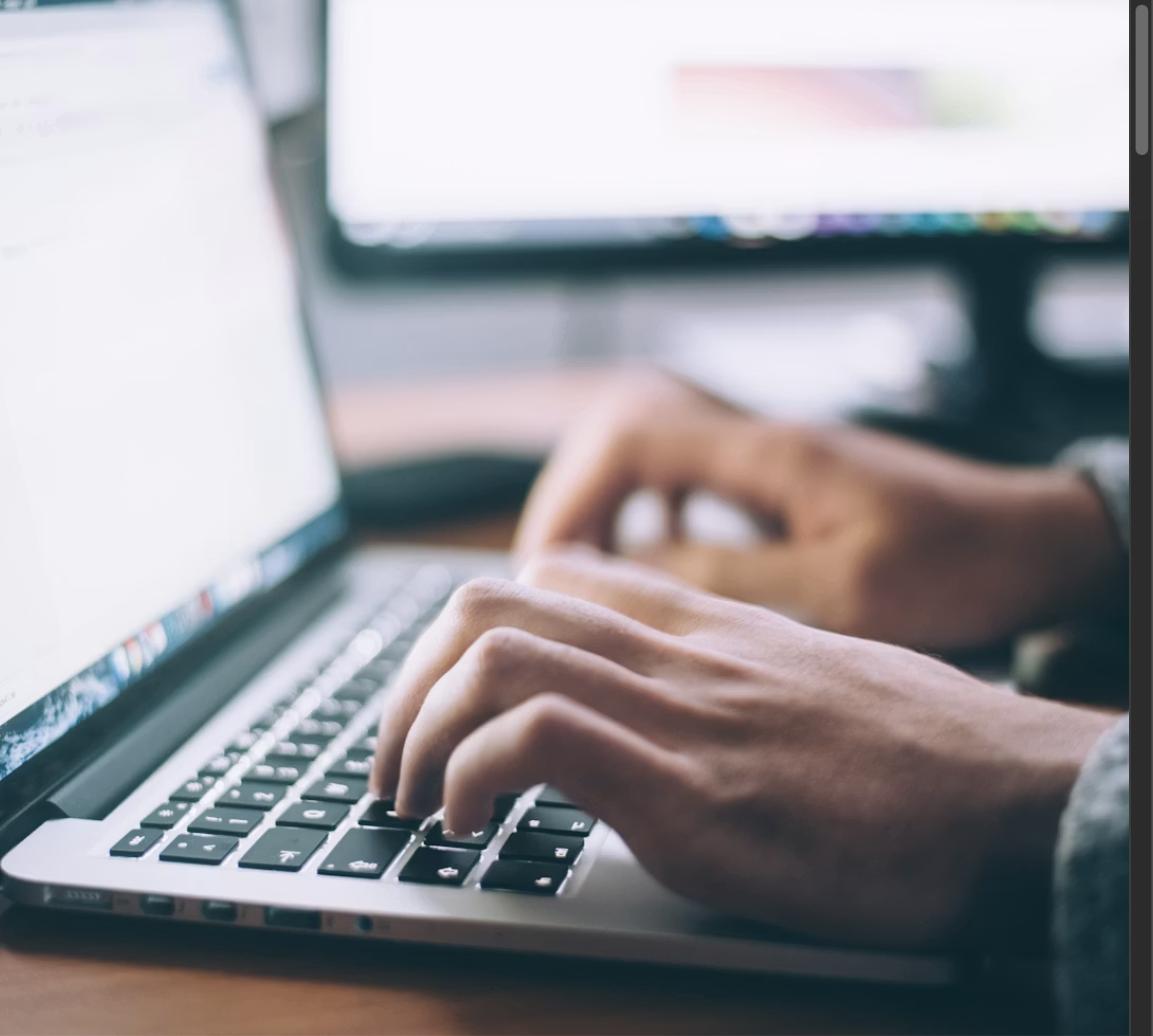 Person typing on laptop keyboard, writing a job application email