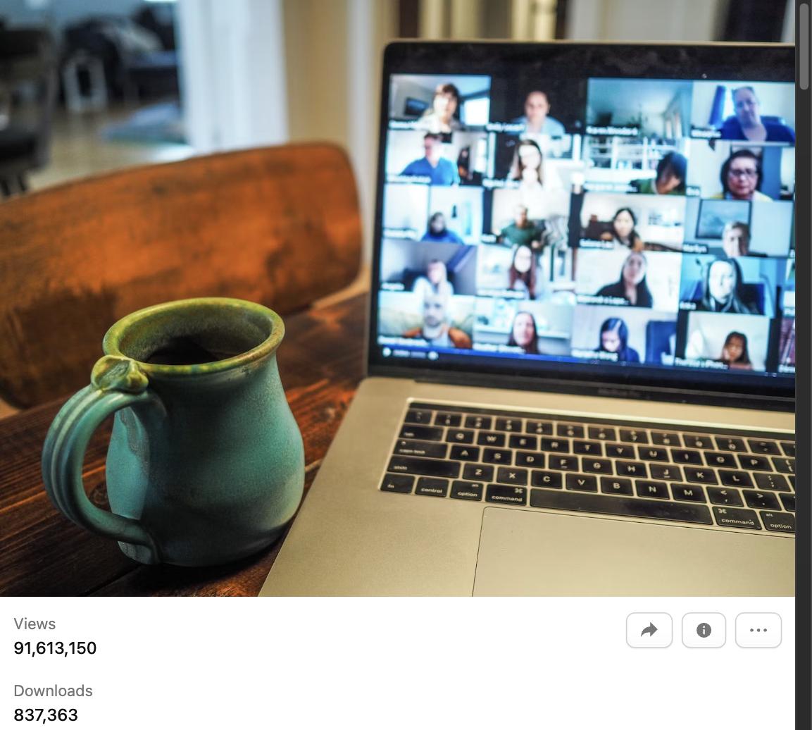 Laptop showing a video call interview with coffee mug on desk