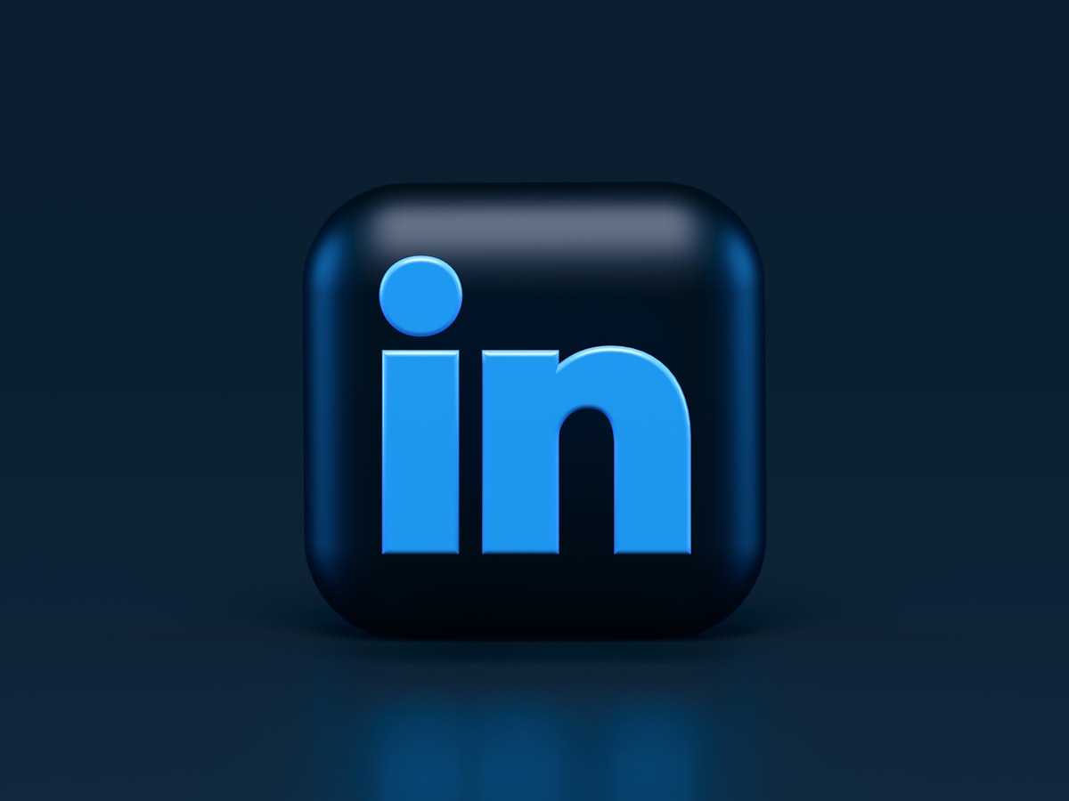 Professional updating LinkedIn profile photo and headline to attract recruiters - build a linkedin profile that attracts recruiters