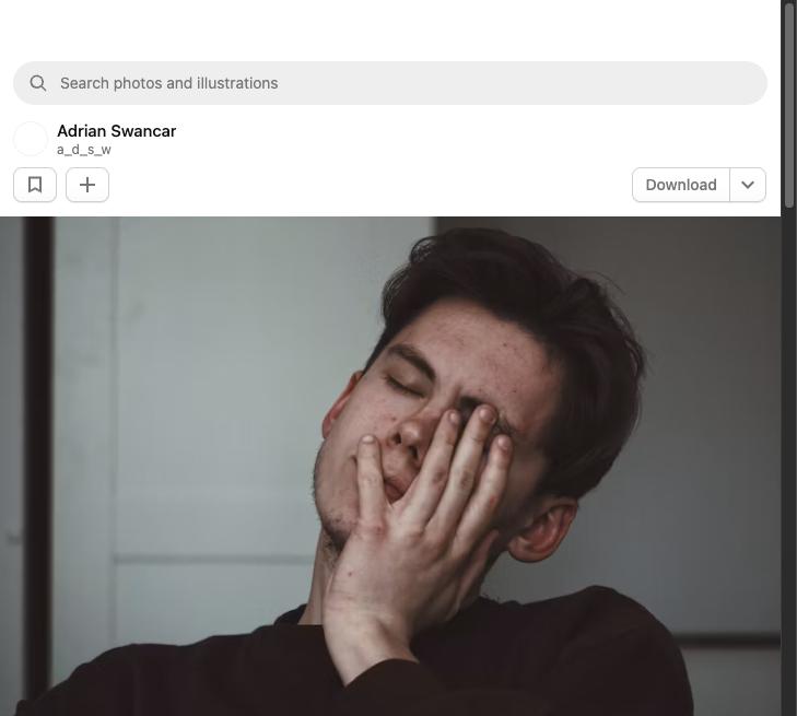 Exhausted man covering his face with his hand, showing burnout