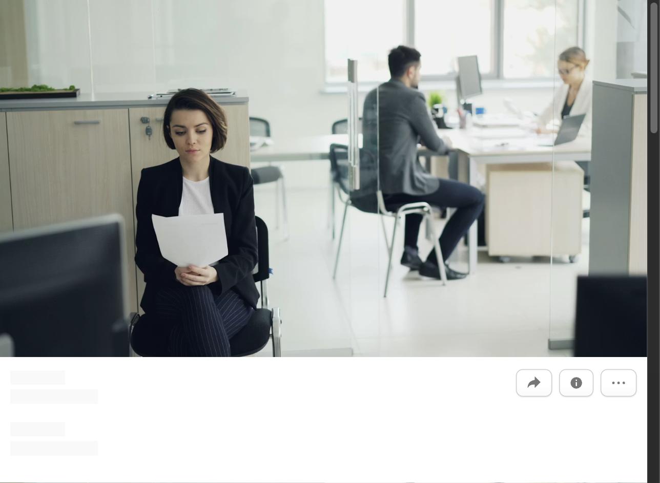 A woman holding papers sitting in a modern office, representing what to do in the first 90 days of a new job