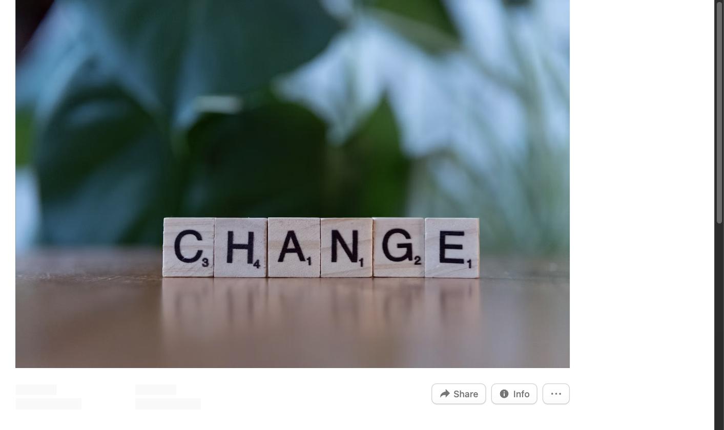 Scrabble tiles spelling the word CHANGE on a wooden table