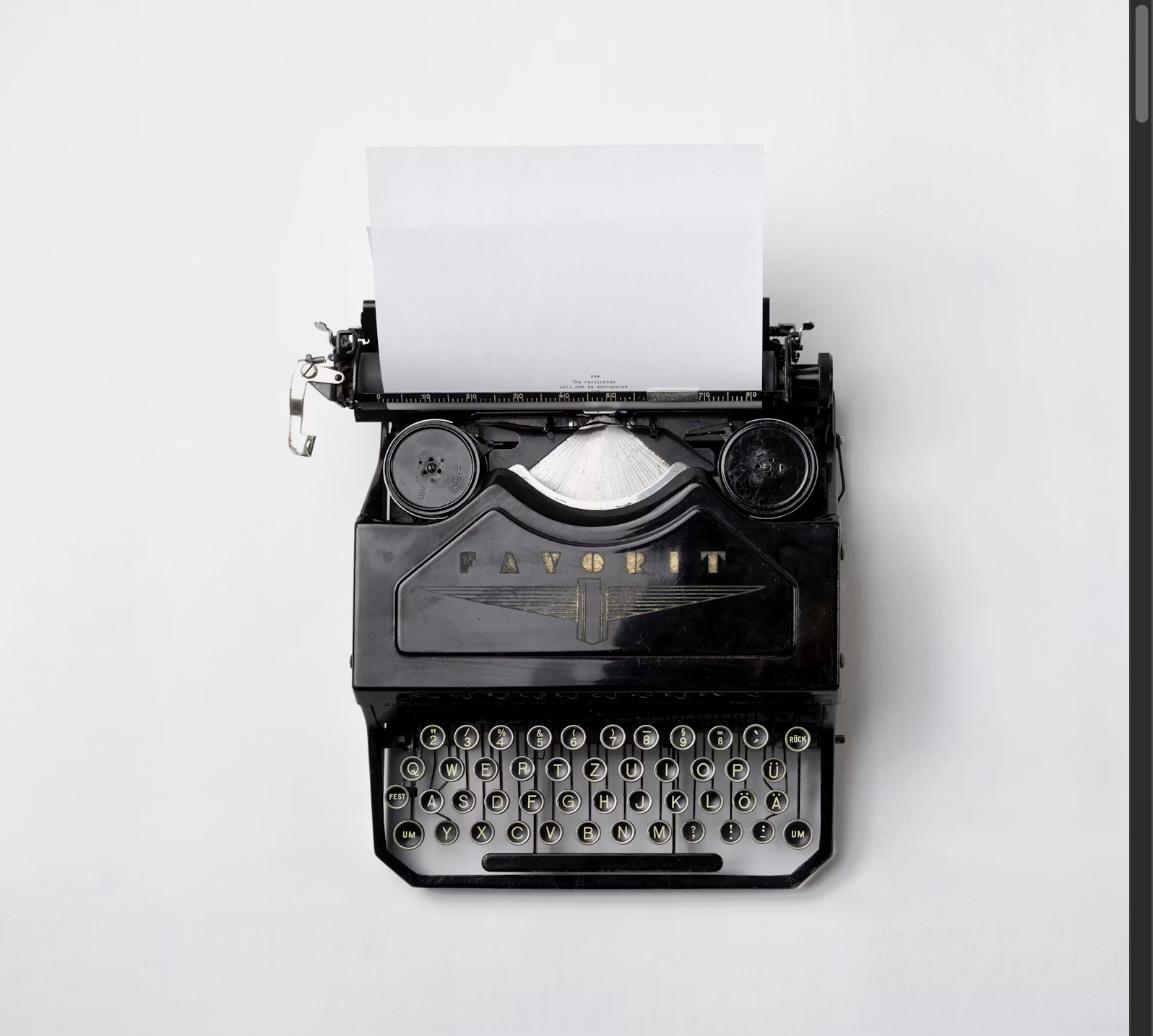 Vintage black typewriter with a blank sheet of paper ready for writing