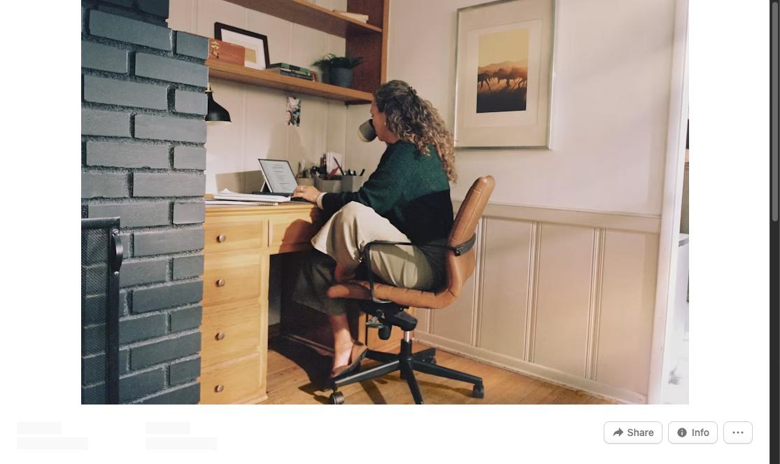 Woman working remotely at a desk in her home office with coffee