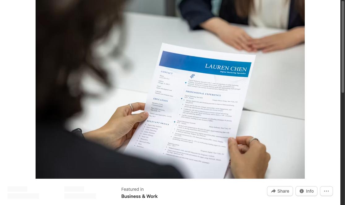 Woman reading and reviewing a printed resume document at a table