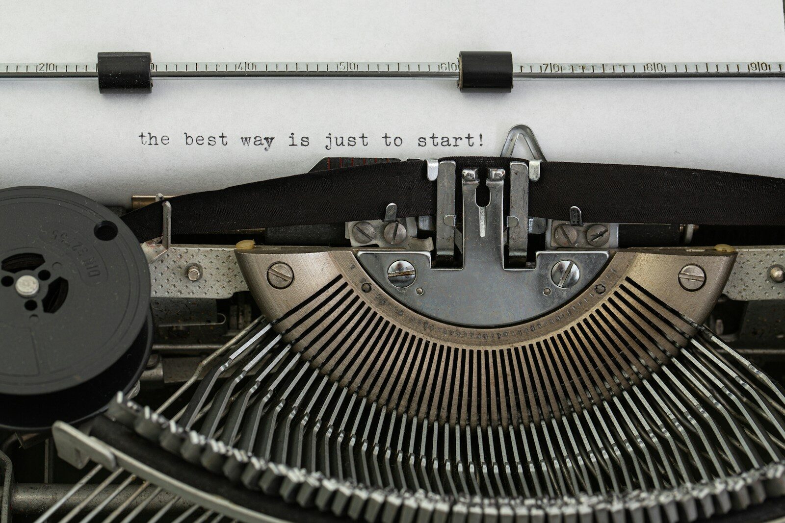 Vintage typewriter with paper reading 'the best way is just to start', representing writing a LinkedIn headline