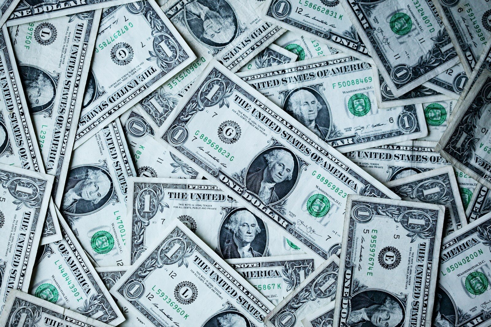 Scattered US dollar bills, representing negotiating salary after a job offer