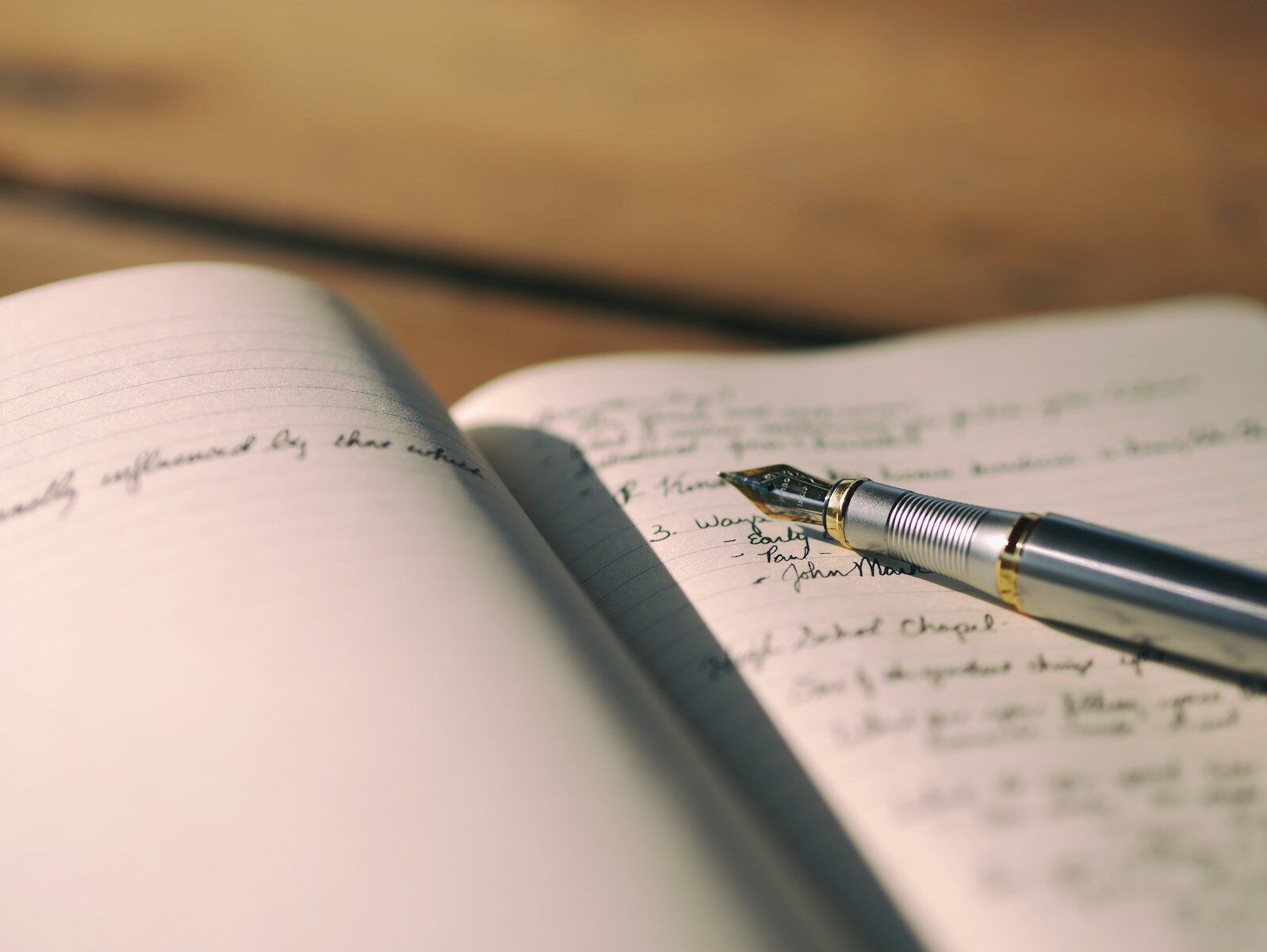 Fountain pen writing on lined paper, representing crafting a compelling LinkedIn About section