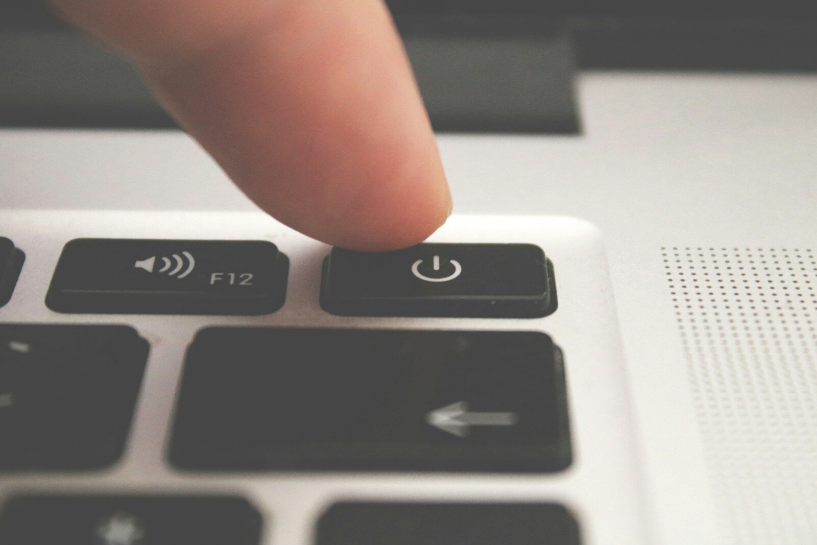 Finger clicking a laptop key, representing choosing between LinkedIn Easy Apply and a direct application