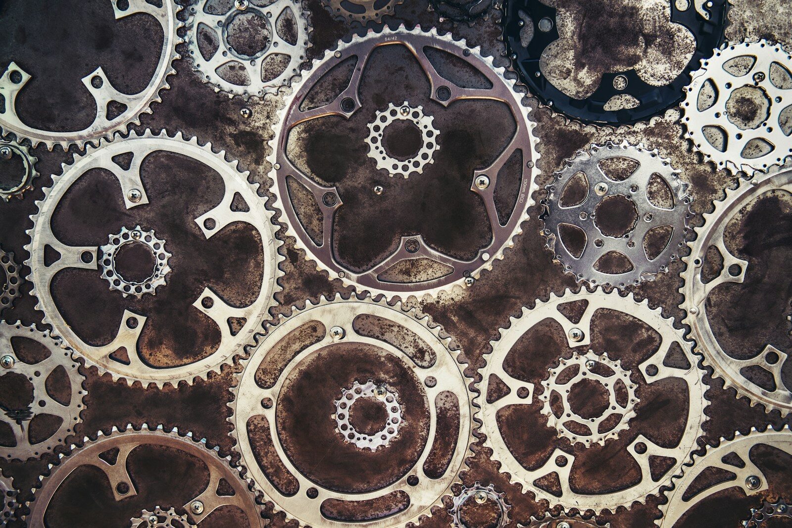 Close-up of interlocking metal gears, representing optimizing a LinkedIn profile for recruiters