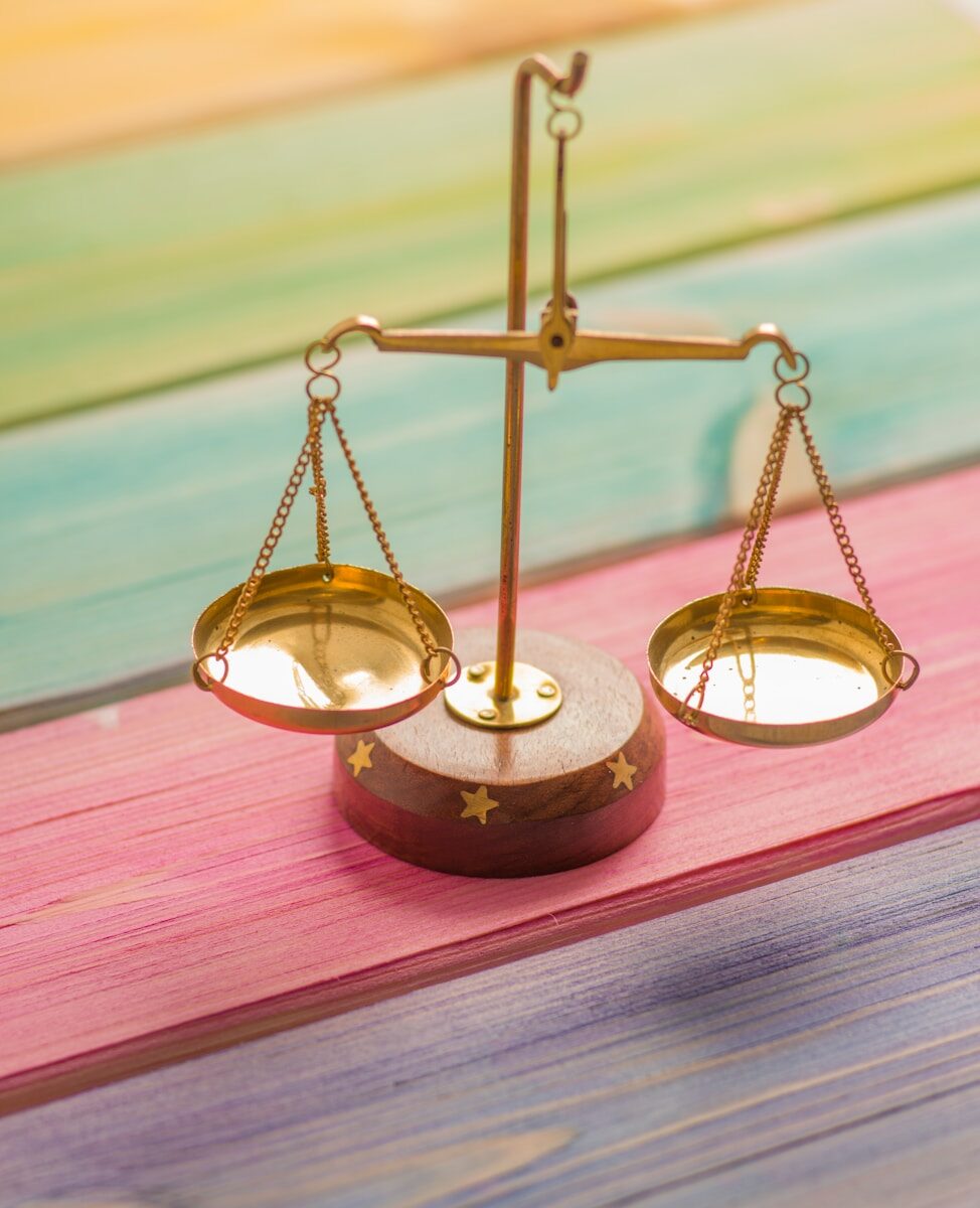 Small gold balance scale, representing weighing a counter-offer against a new job opportunity