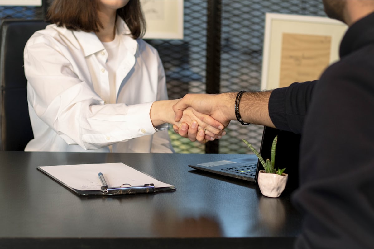 Handshake in an office representing a job offer agreement
