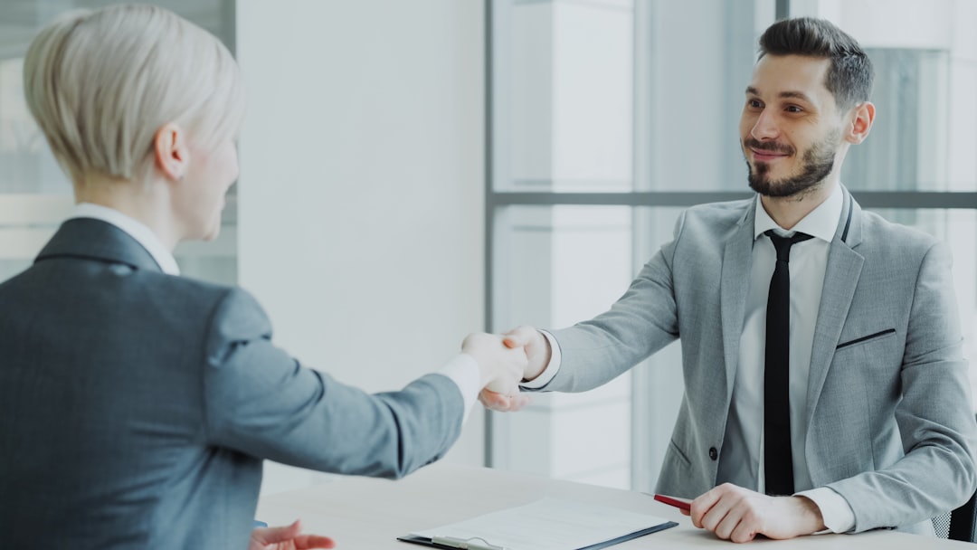Hiring manager shaking hands with a candidate after a job interview