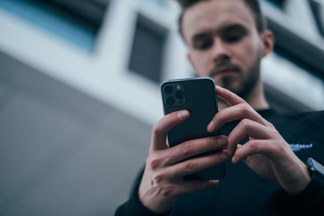 Person holding a personal phone, representing a discreet job search while employed
