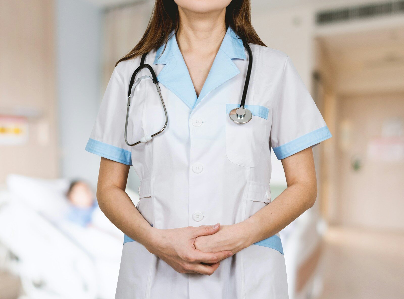 woman in white button up shirt and blue stethoscope - nurse resume guide