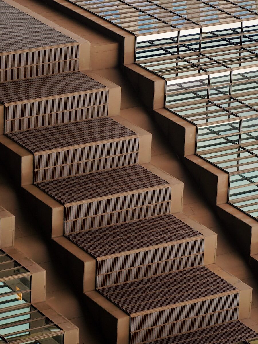 Modern wooden staircase leading upward, symbolizing career progression within a company