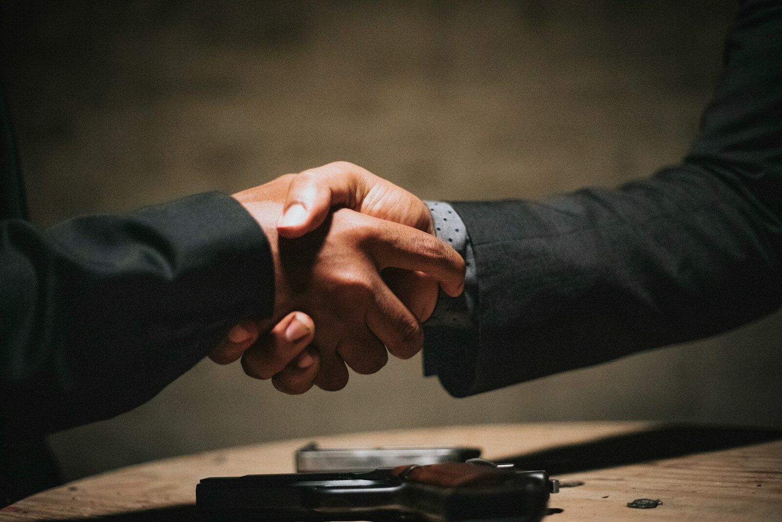 Two colleagues shaking hands after a promotion announcement