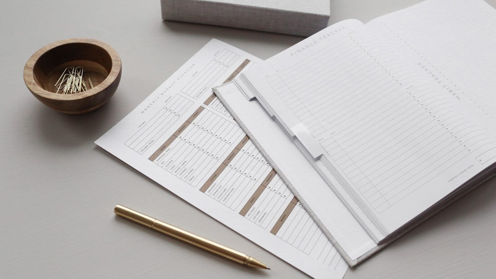 Stapled resume papers with a pen on a desk, comparing a resume to a LinkedIn profile