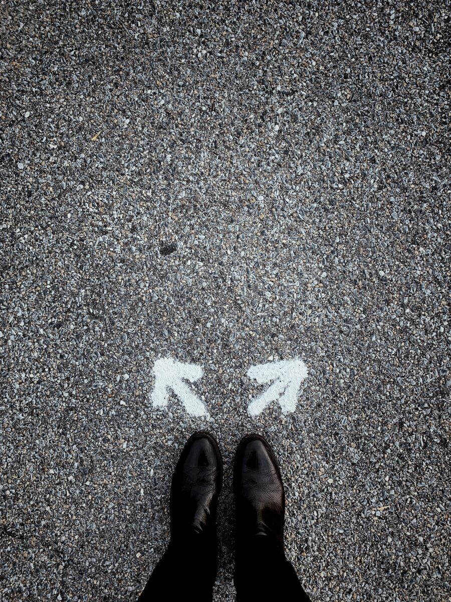 Person standing at a crossroads deciding which career path to take