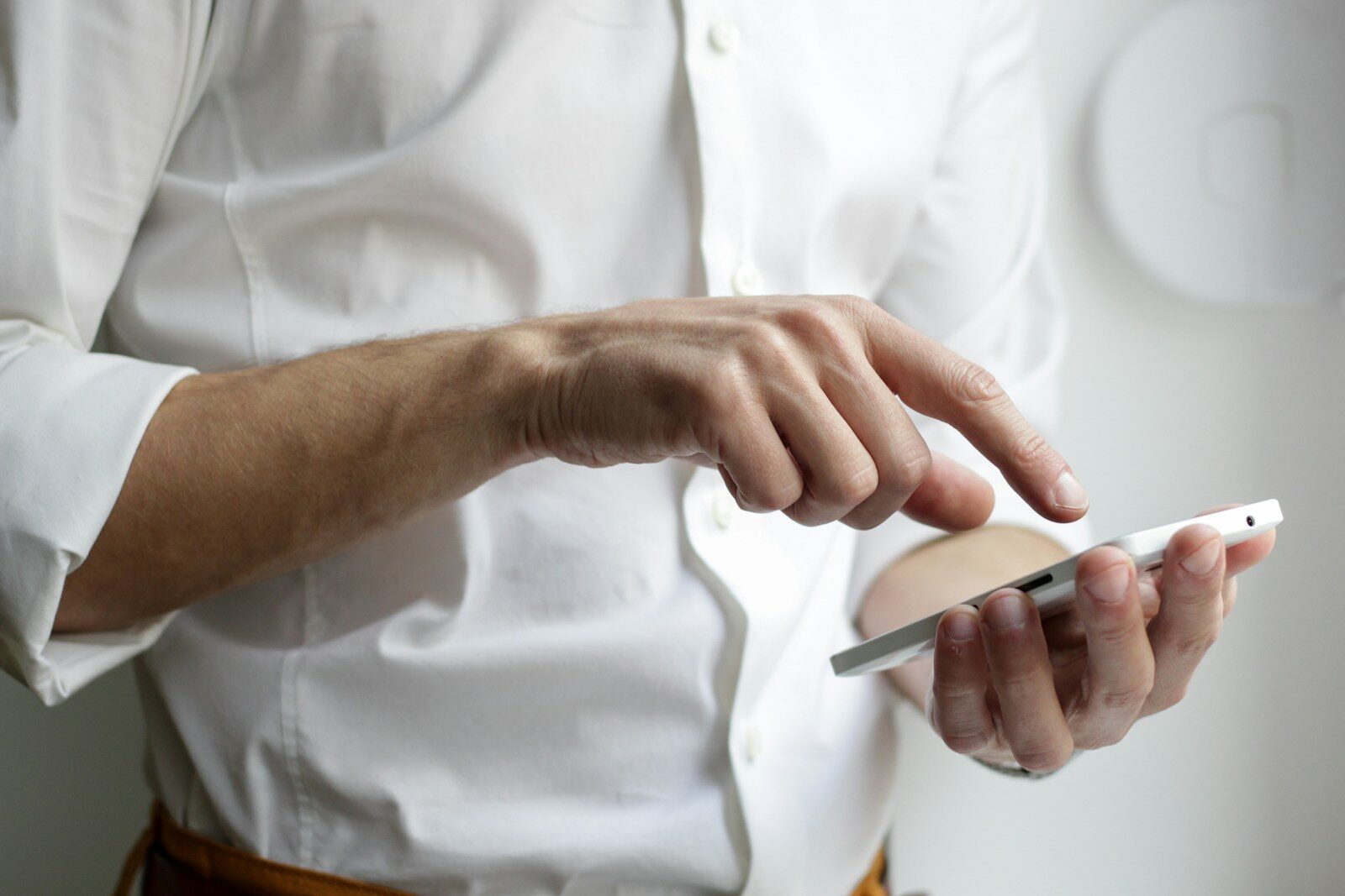 Person typing on a smartphone, representing filling out a job application in the AI era