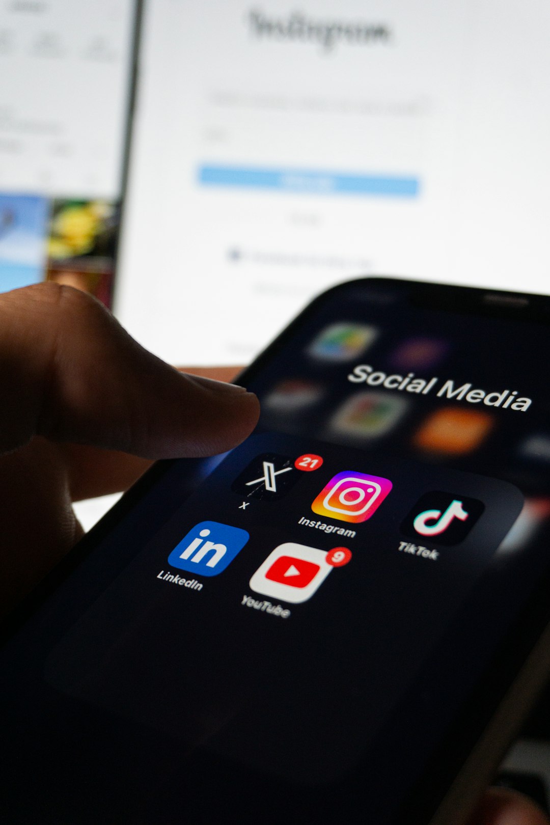 Person browsing social media apps on a phone, representing using online communities for a job search