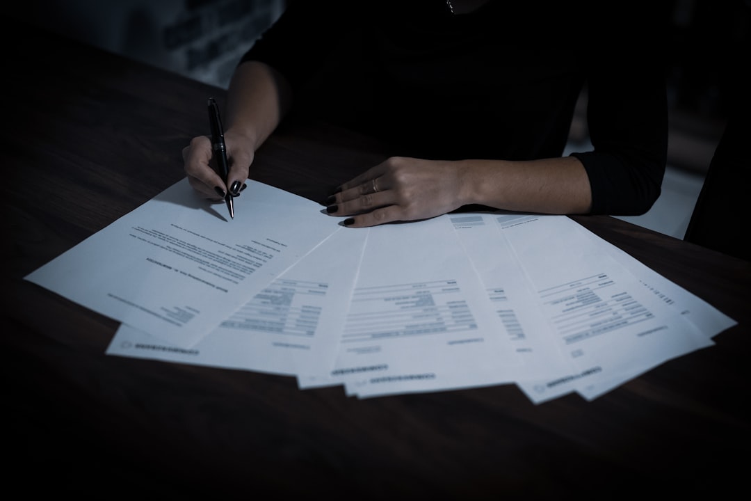 Person signing a document, representing salary transparency law compliance