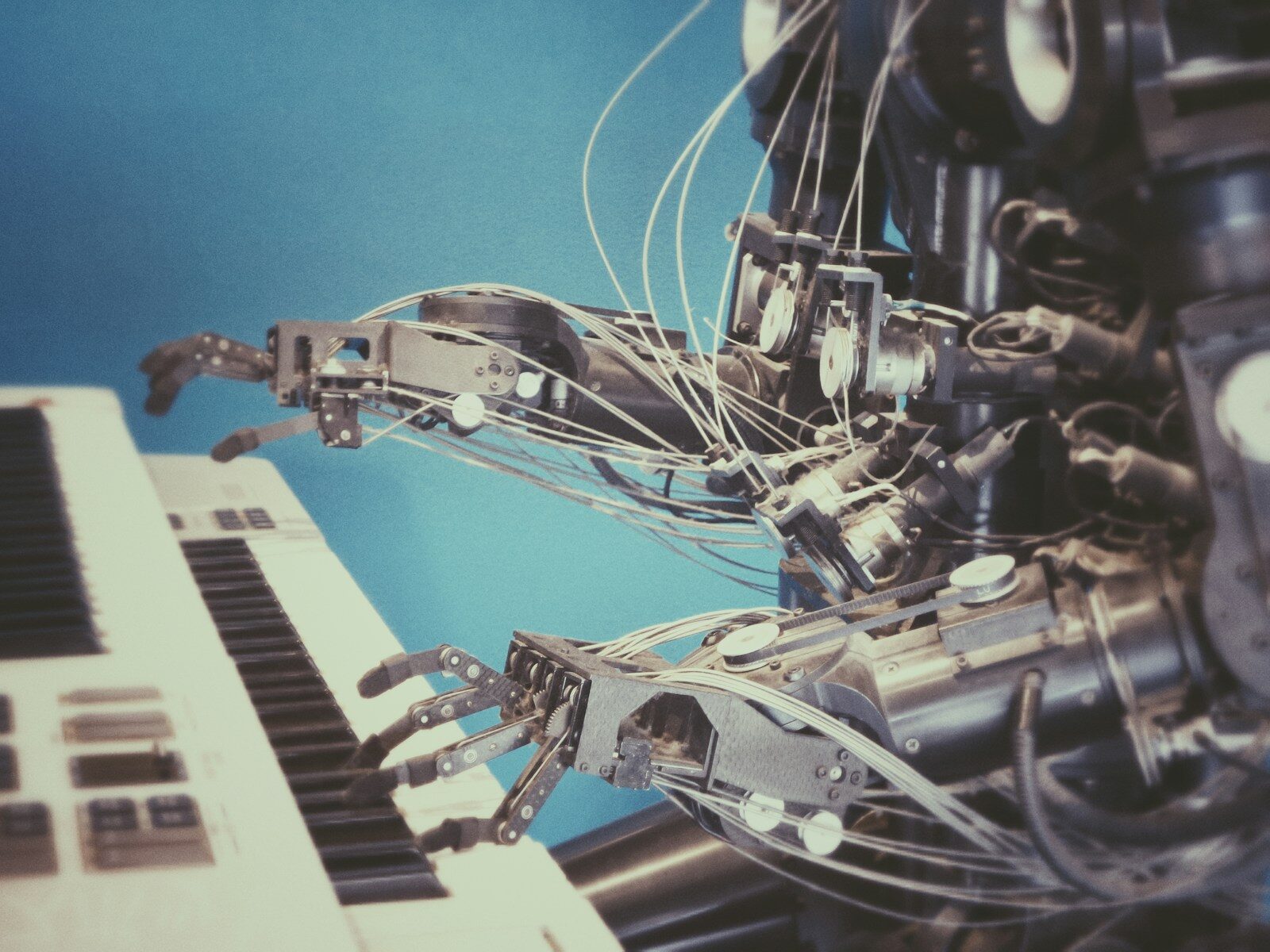 Robotic hand interacting with a keyboard, representing AI resume writing tools