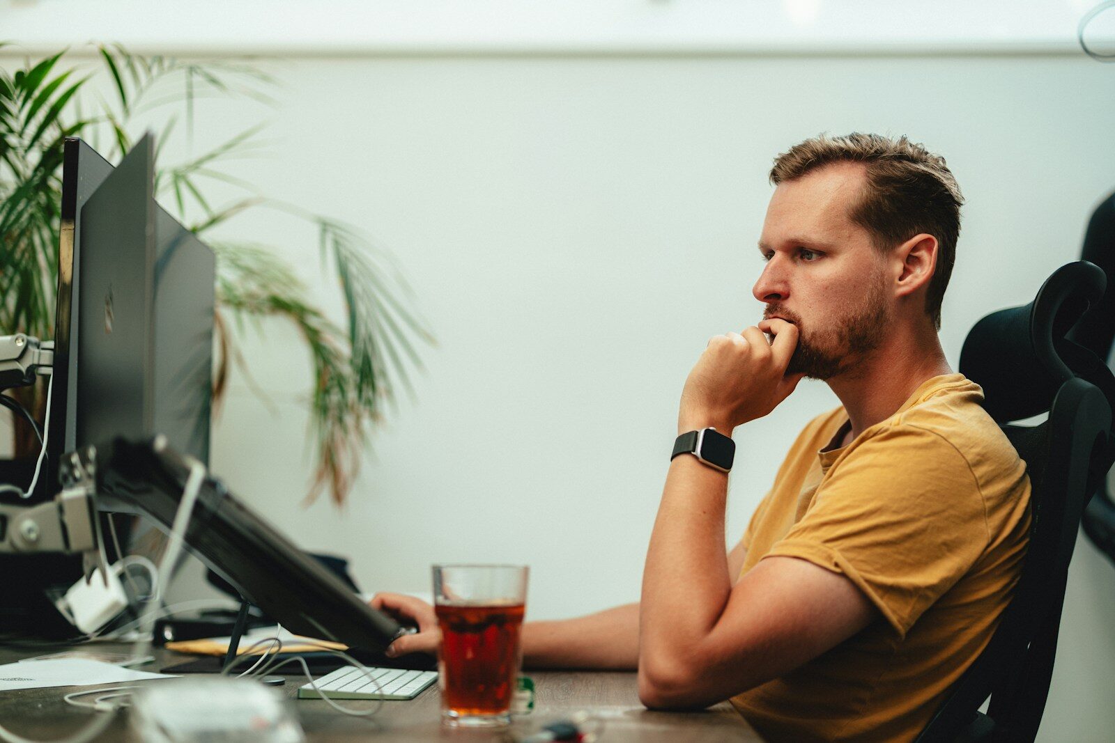 Man sitting at desk looking thoughtful, dealing with imposter syndrome at work