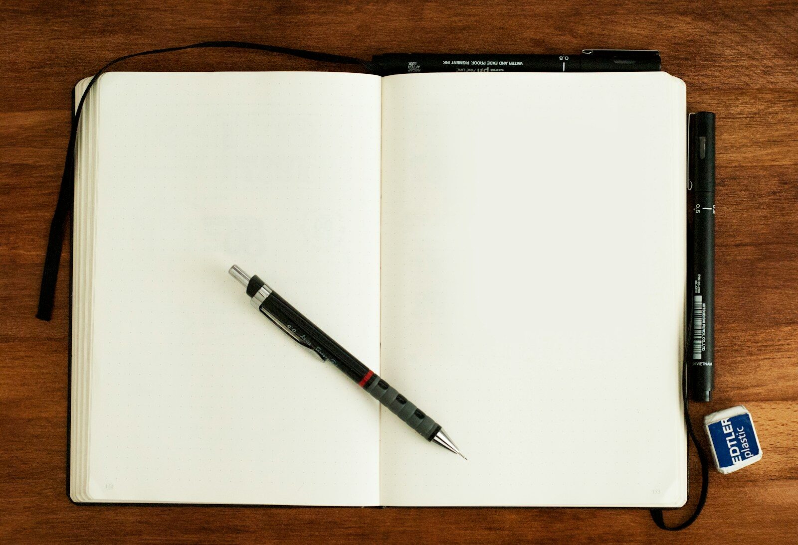 Open journal and pen representing hobbies and interests on your resume