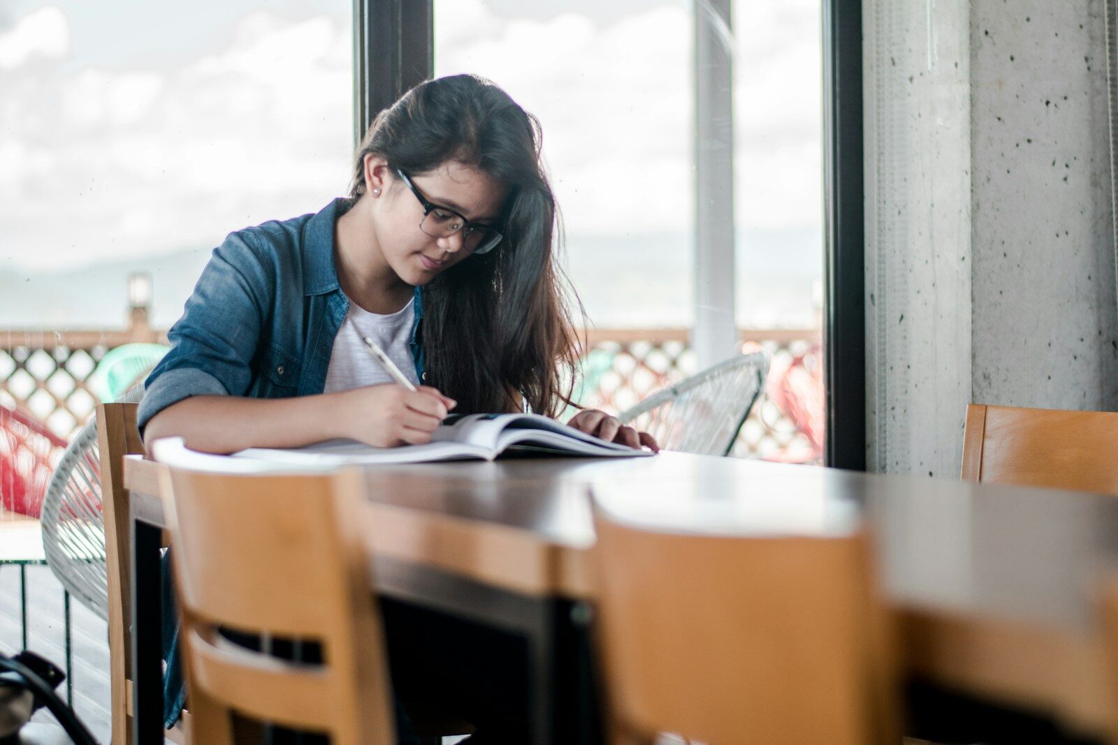 Become a nurse: a nursing student studying and taking notes, illustrating the coursework required before sitting for the NCLEX-RN exam