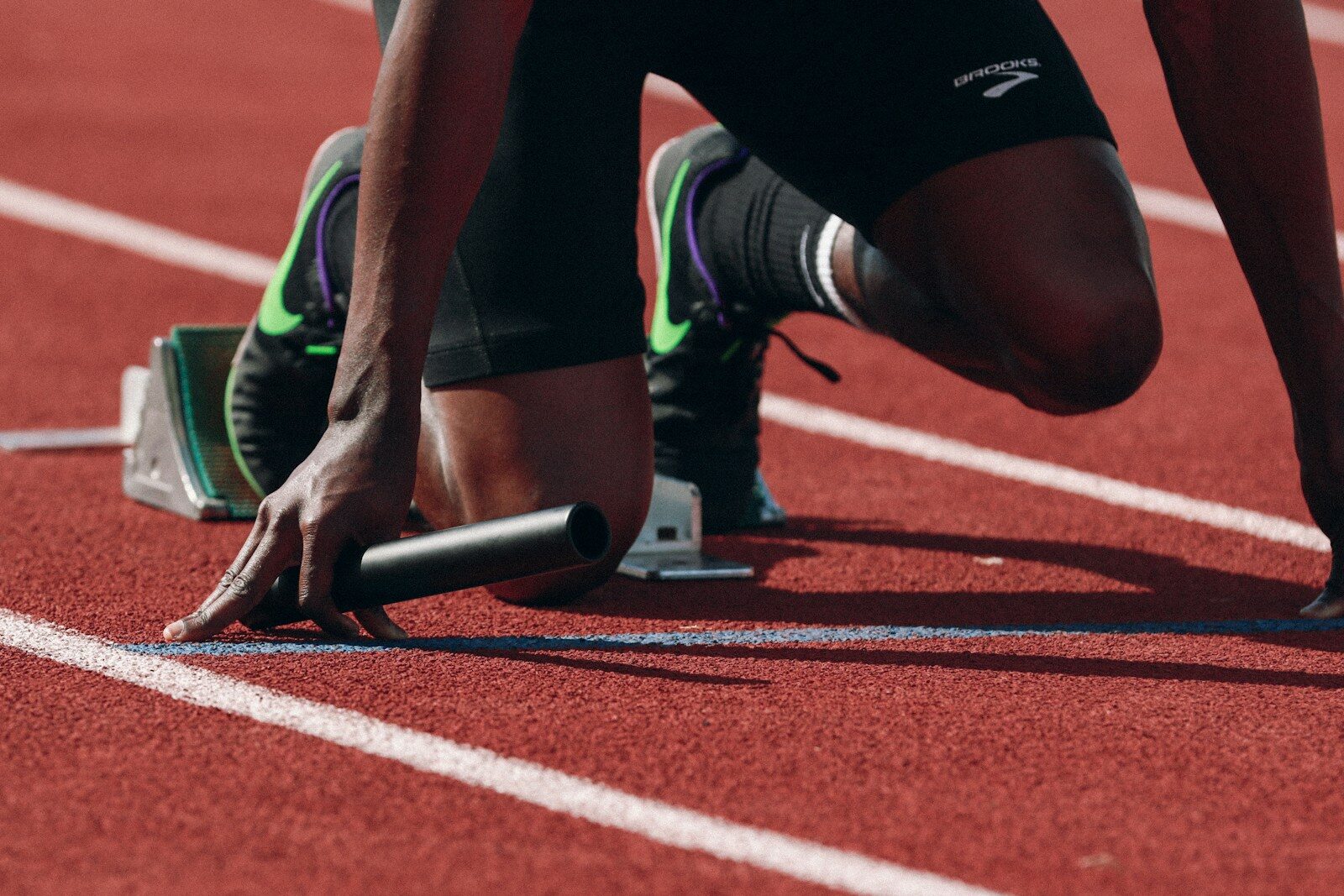 Runner in starting blocks on a track, representing writing a resume from scratch