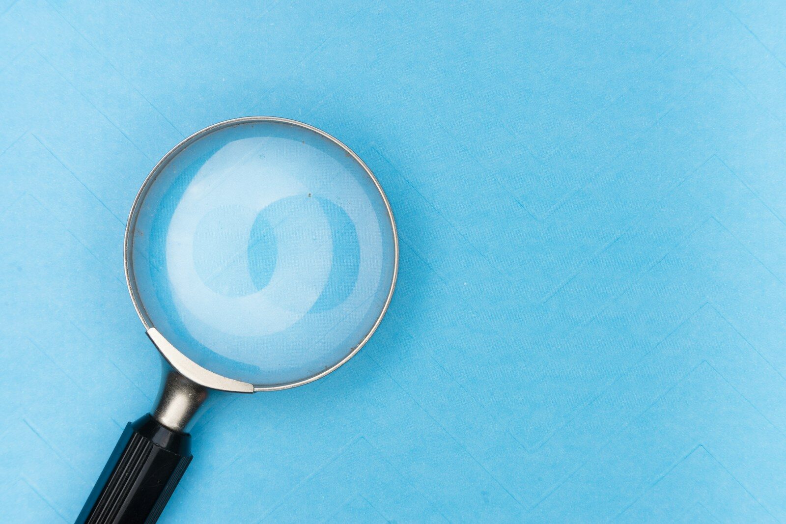 Magnifying glass over a document, representing what employers look for when reviewing a candidate