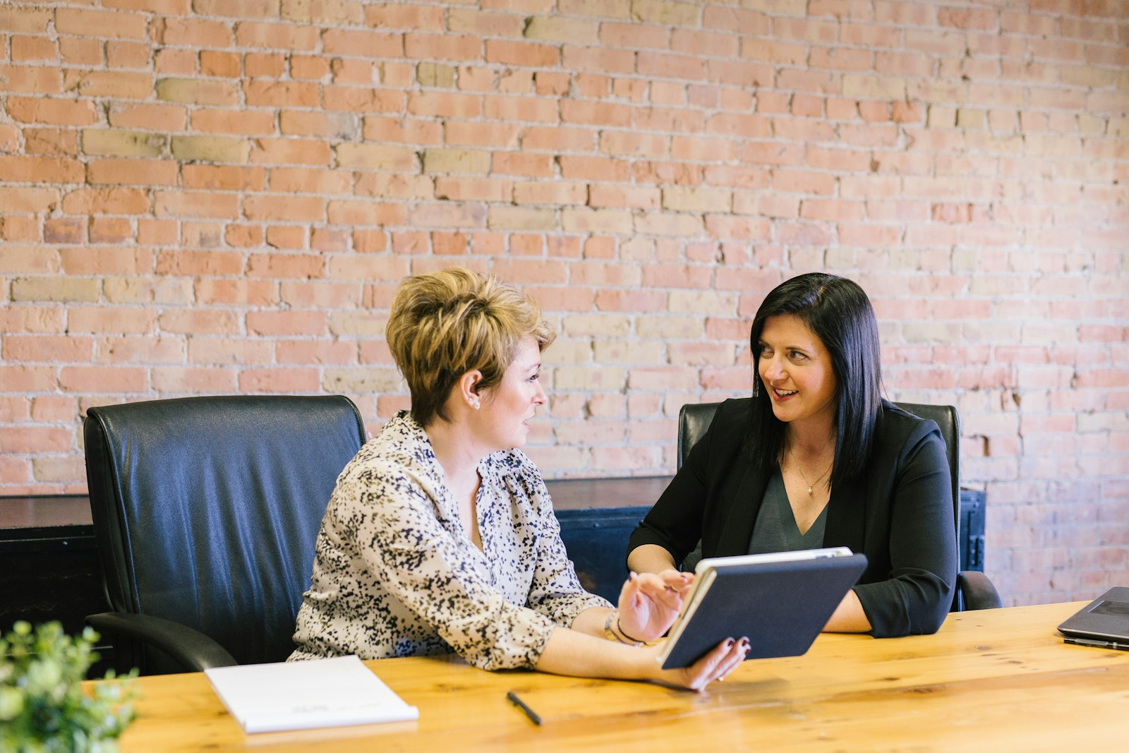 Two colleagues discussing a continuing education career plan in an office
