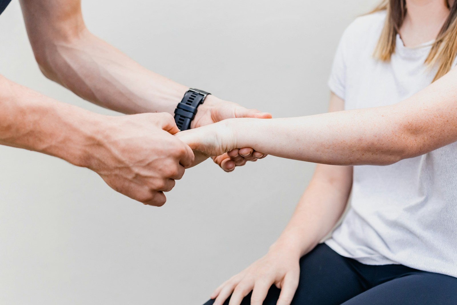Close-up of hands and wrist, illustrating the physical strain of hands-on therapy work