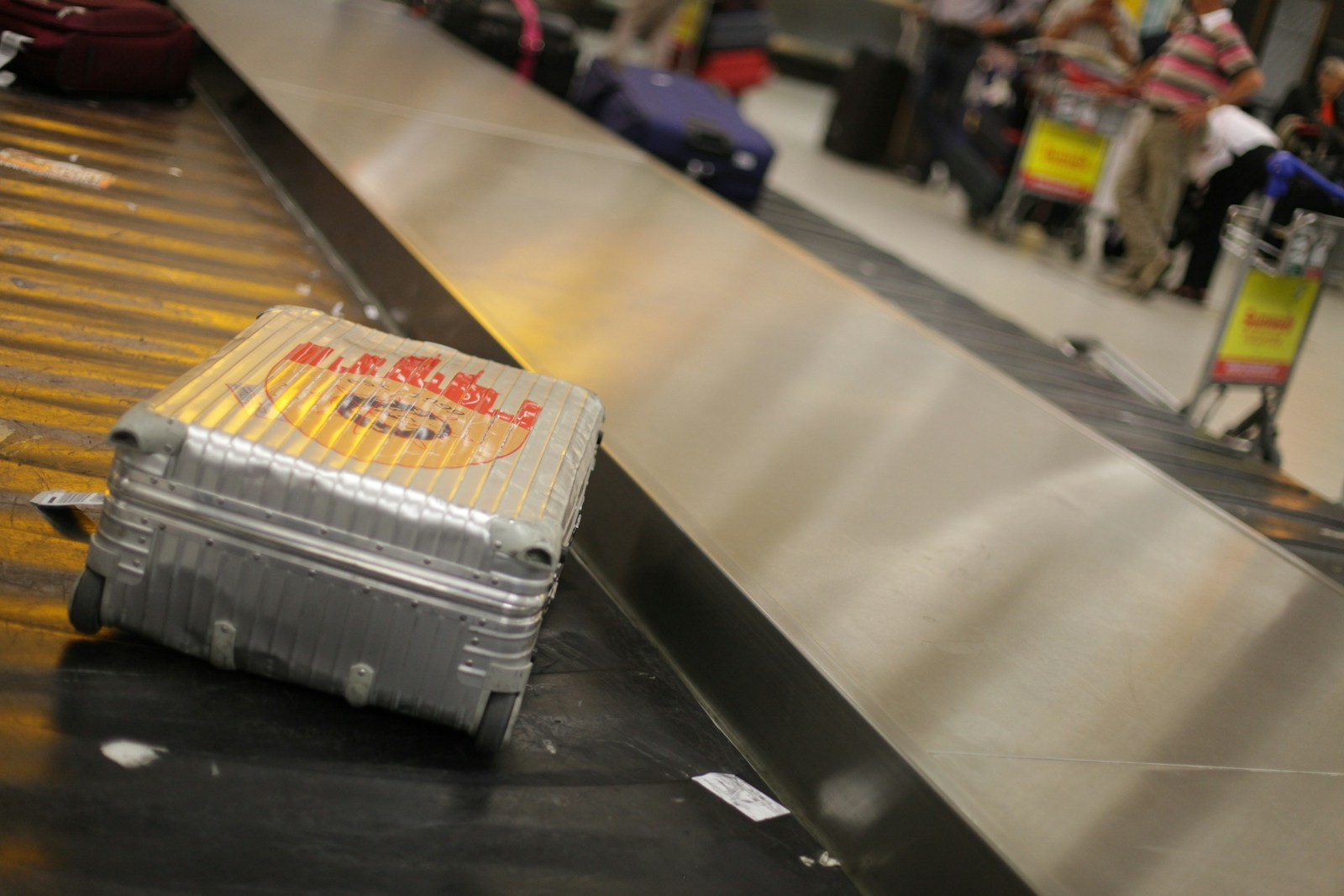 Packing for travel radiology jobs: a suitcase on an airport baggage carousel