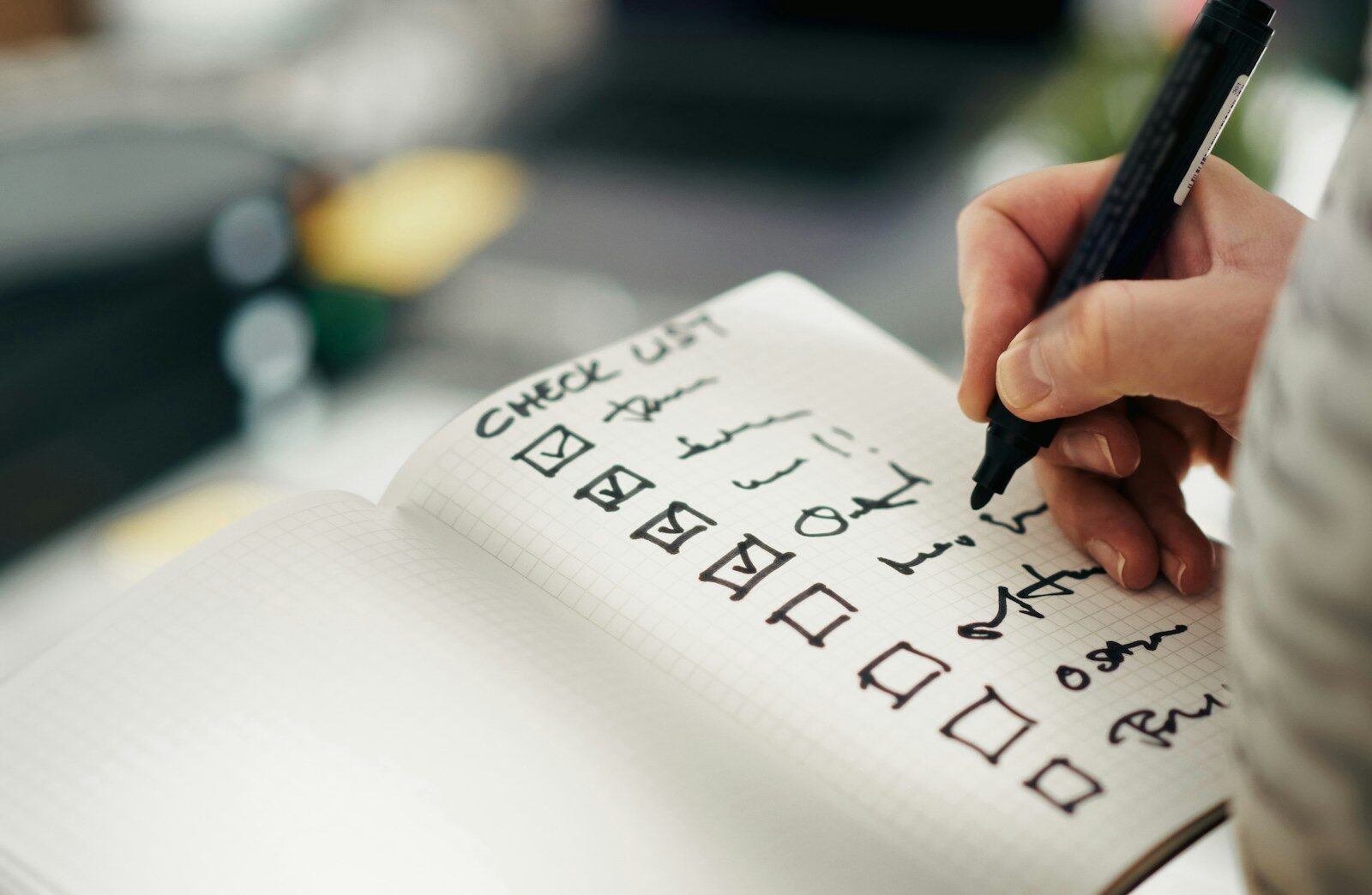 Hand checking off items on a checklist, representing reviewing your final resume