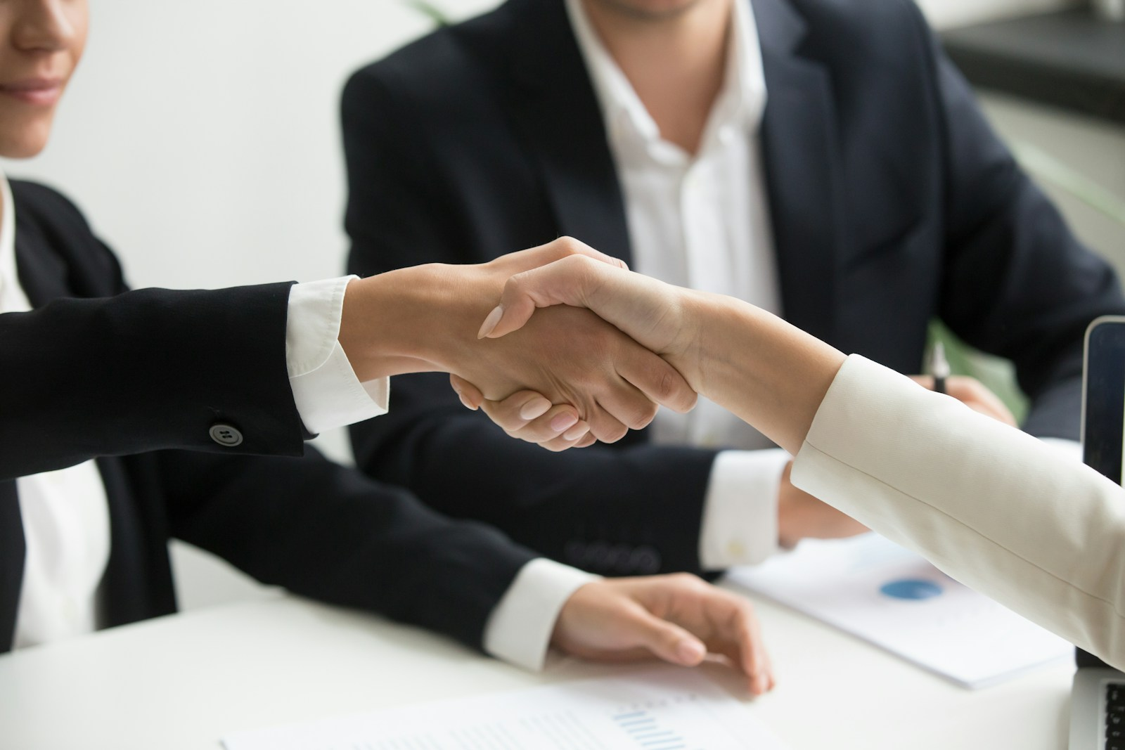 Salary negotiation tips: two professionals shaking hands after reaching an agreement