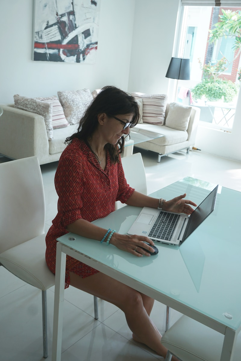 A virtual assistant working at a laptop with real estate listings on screen, illustrating the role and uses of real estate virtual assistant support