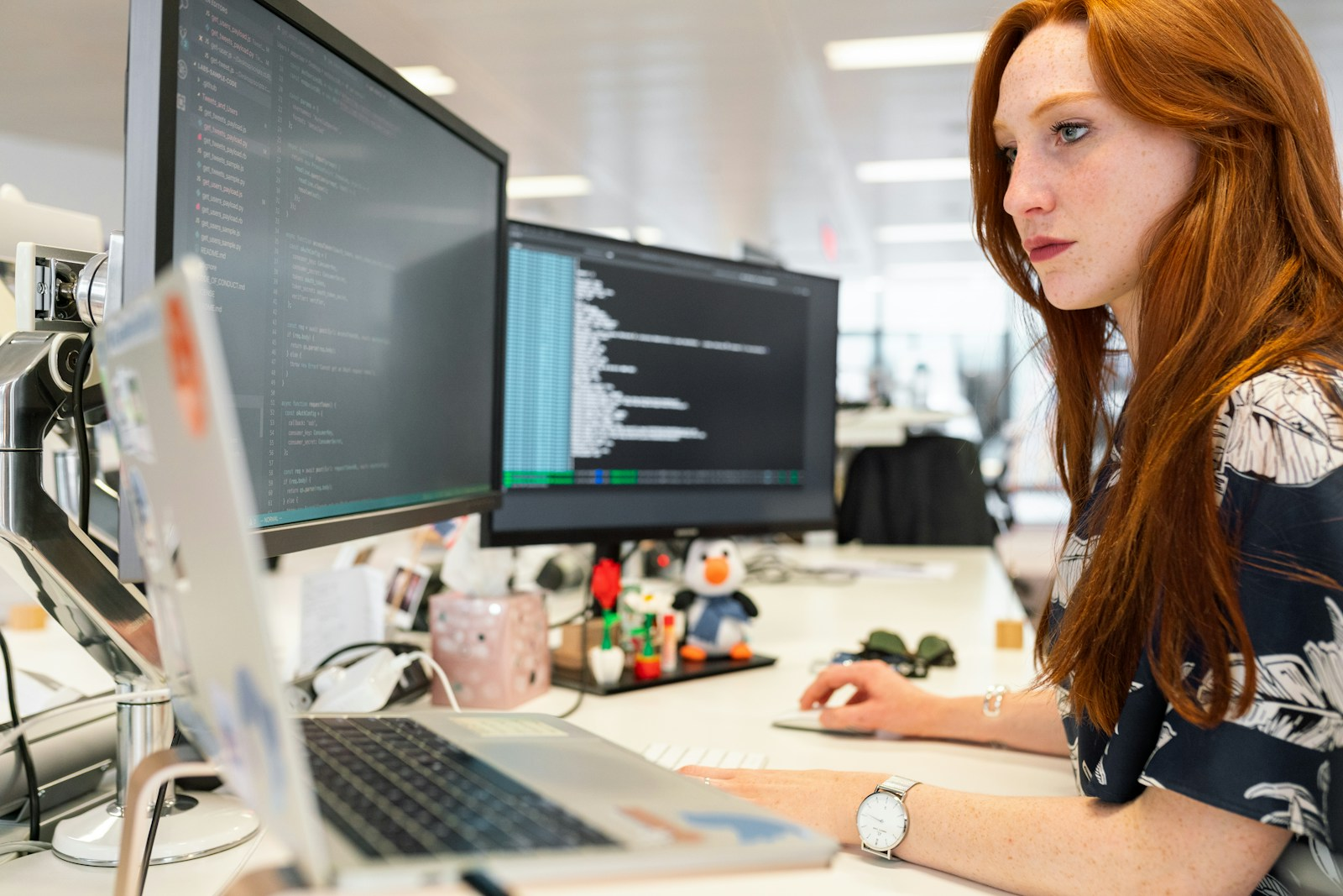 A young woman coding at a laptop, illustrating skills-building programs for the new generation of young women leaders