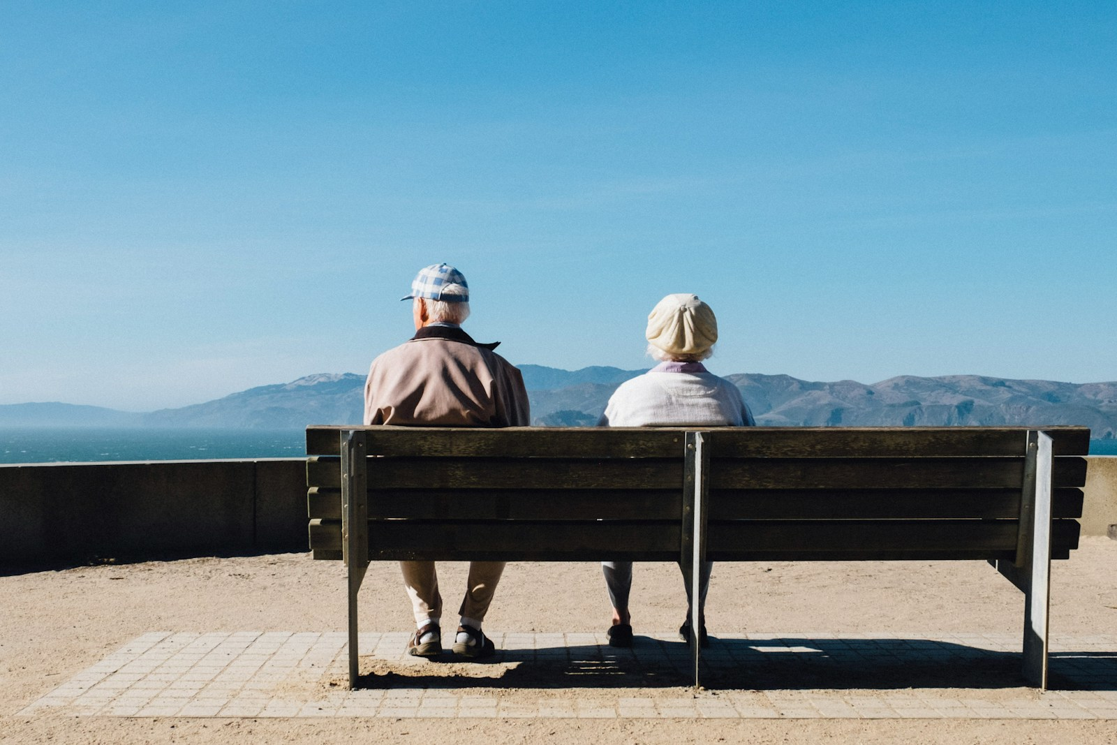 Two older adults sitting together, illustrating the aging population driving the future of nursing home jobs