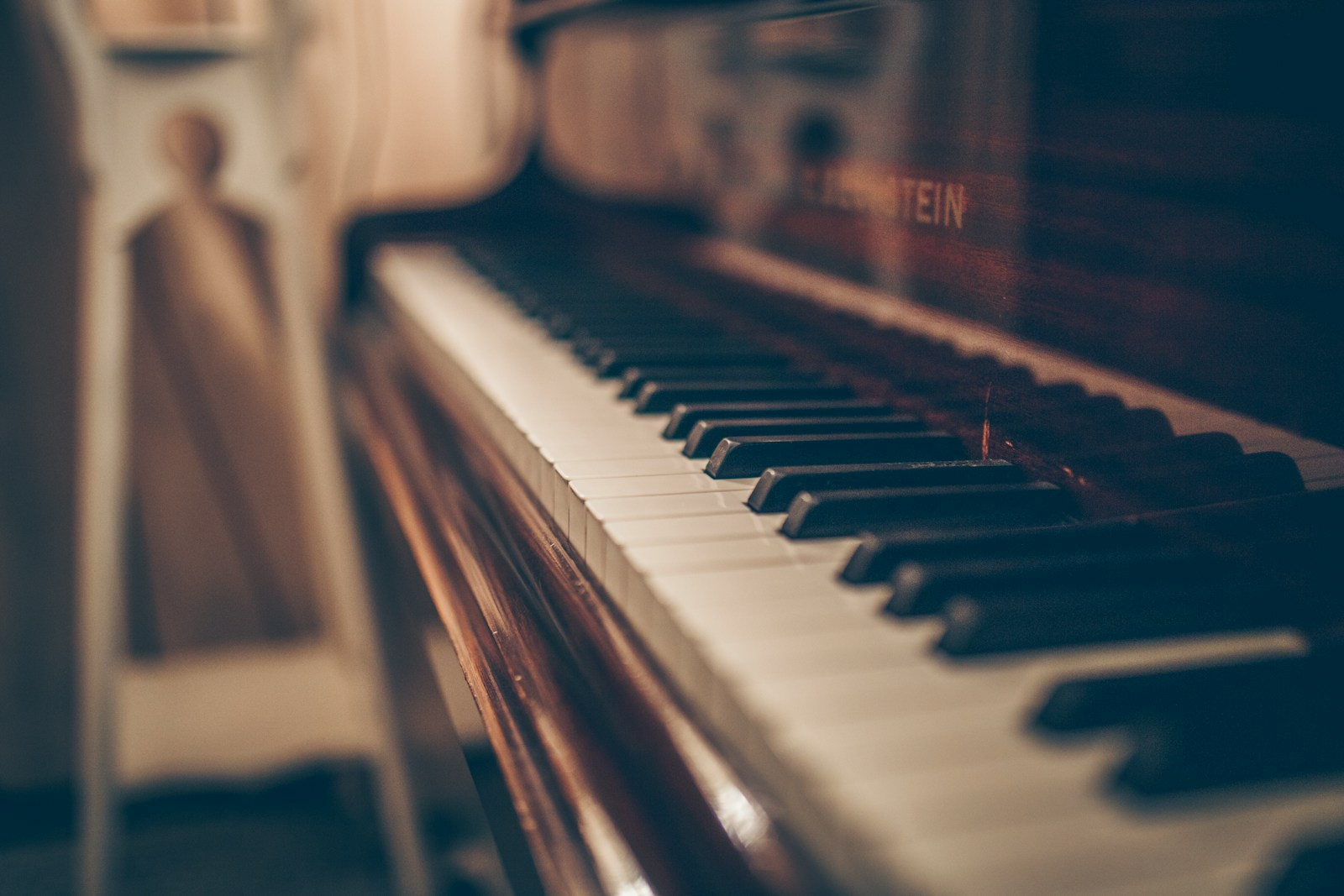 A piano teacher giving a lesson, representing music teacher jobs in a school setting