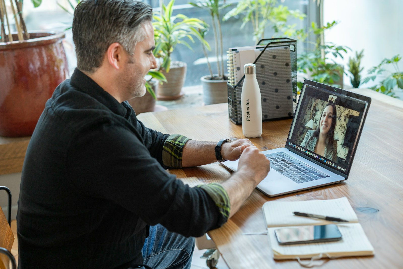 A professional on a video call from home, illustrating the key advantages of telecommuting