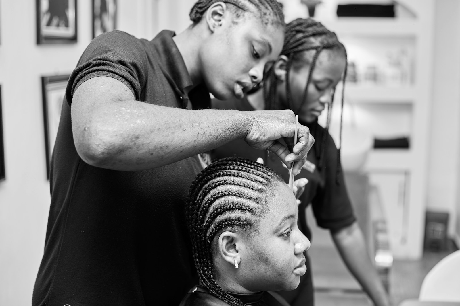 A cosmetologist styling a client's hair in a salon, representing the licensed cosmetology profession