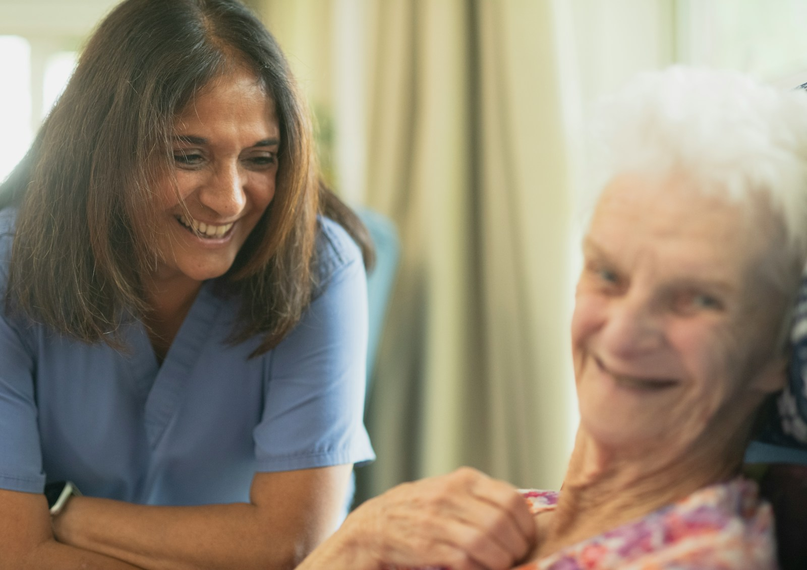 A caregiver assisting an elderly resident, representing the future of nursing home jobs