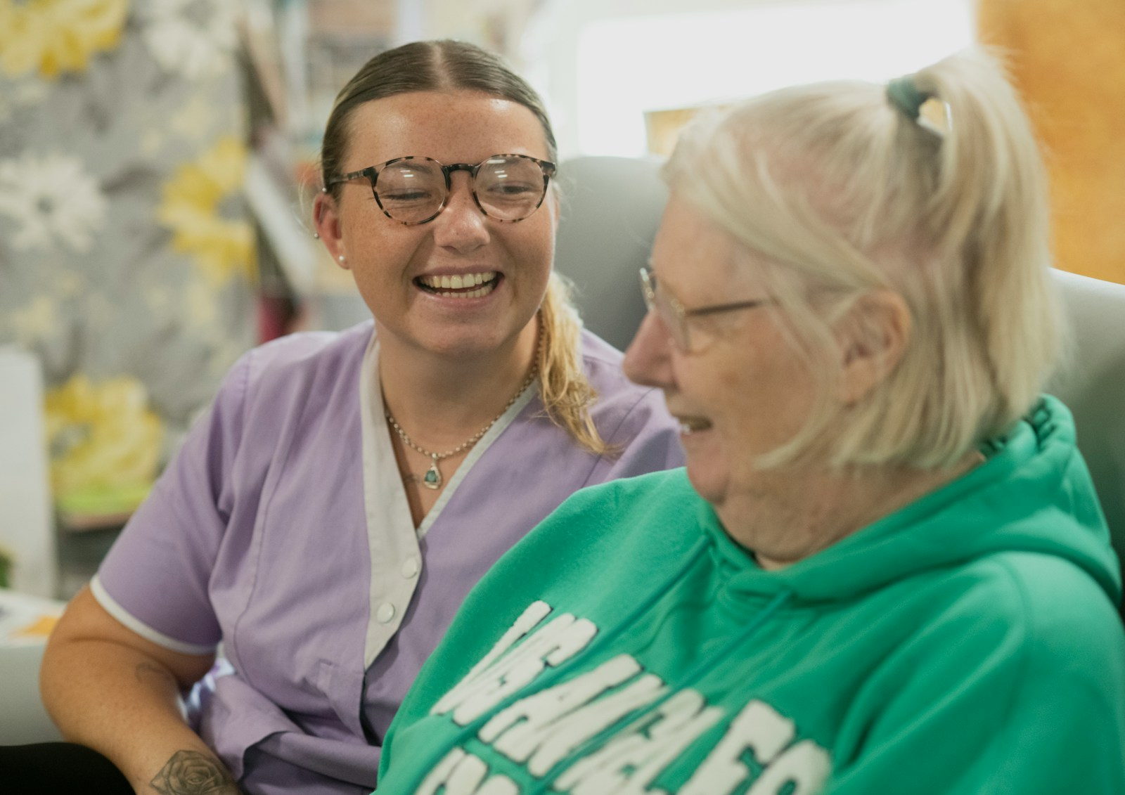 A nurse sitting and talking with a patient, illustrating the importance of bedside manner in nursing