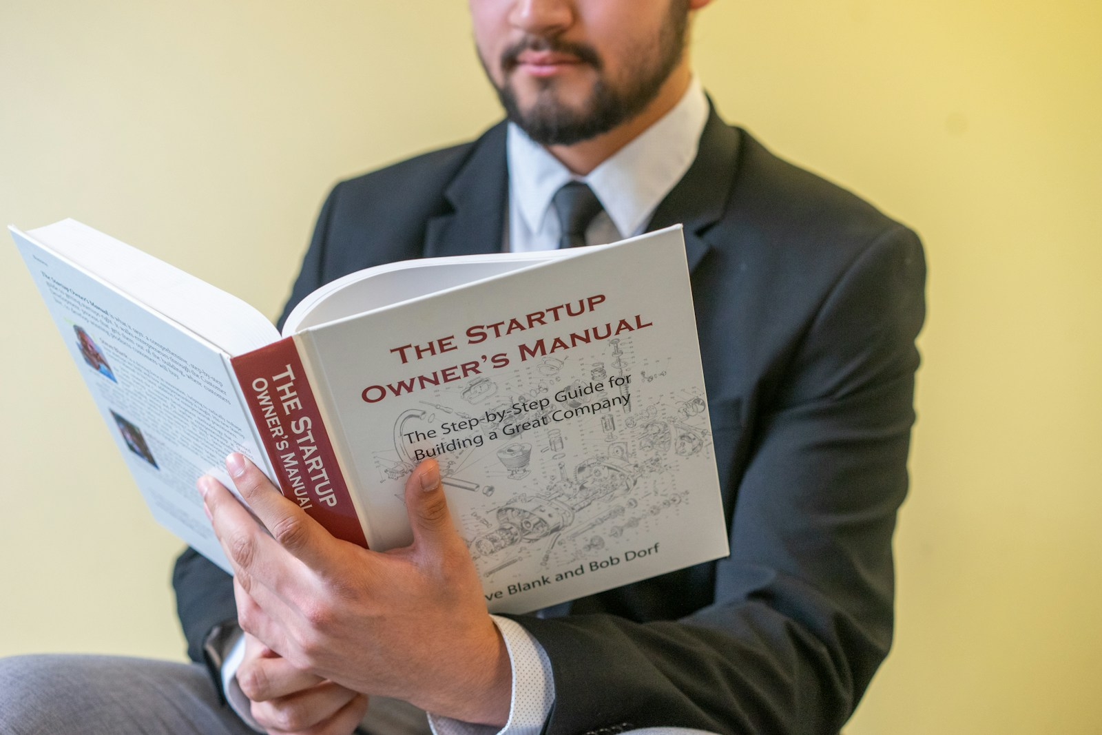 A professional reading a manual, illustrating the implied contract exception to the at-will employment doctrine