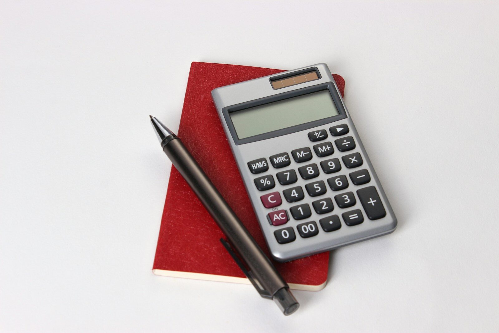 A calculator and notebook on a desk, representing the pricing decisions involved in starting a tutoring business